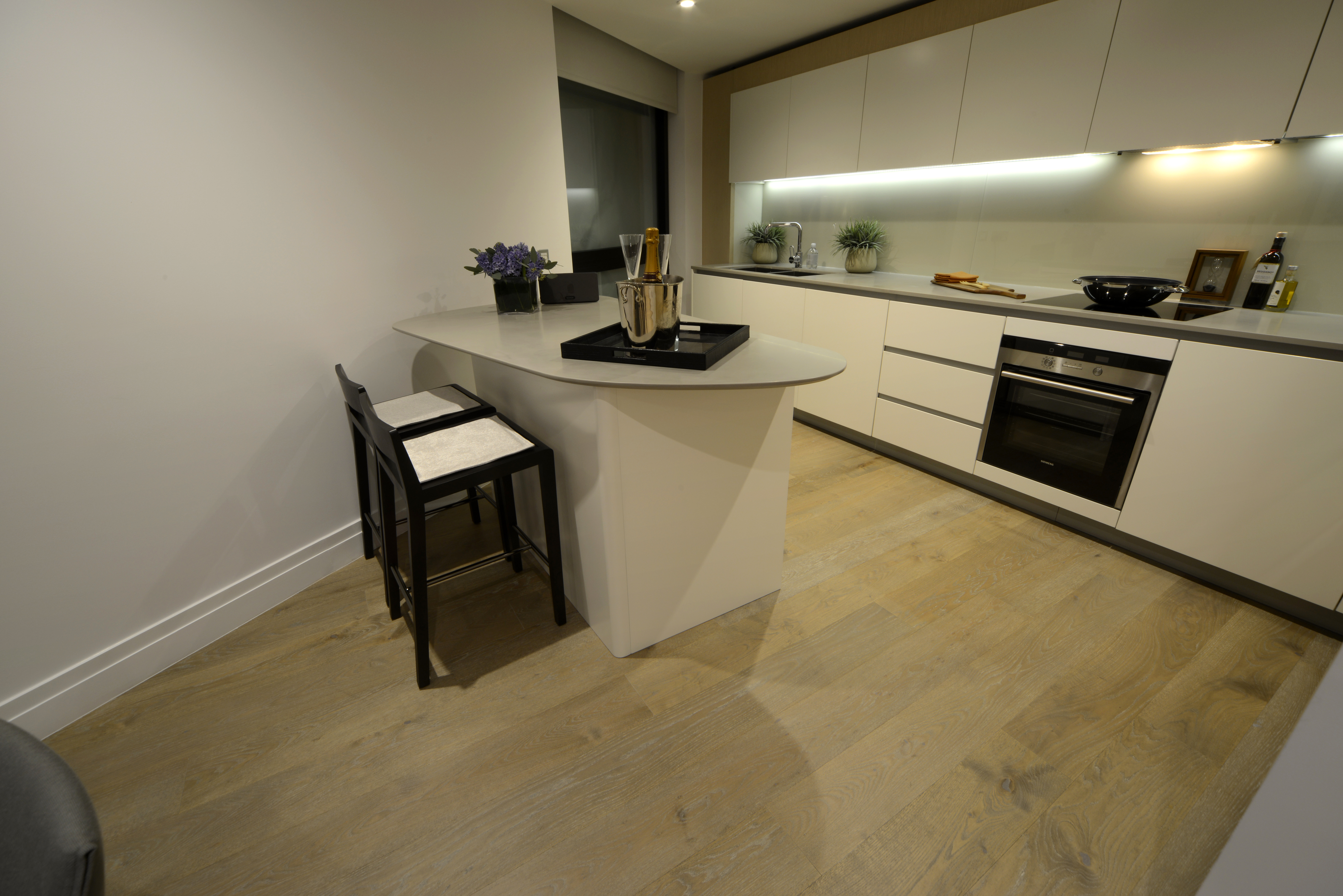 Fumed and Limed Lacquered Oak Floor fitted in kitchens throughout high rise development in London