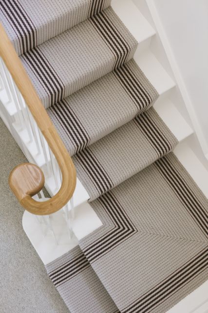 Roger Oates stair runner and oak handrail on new staircase in traditional cottage 