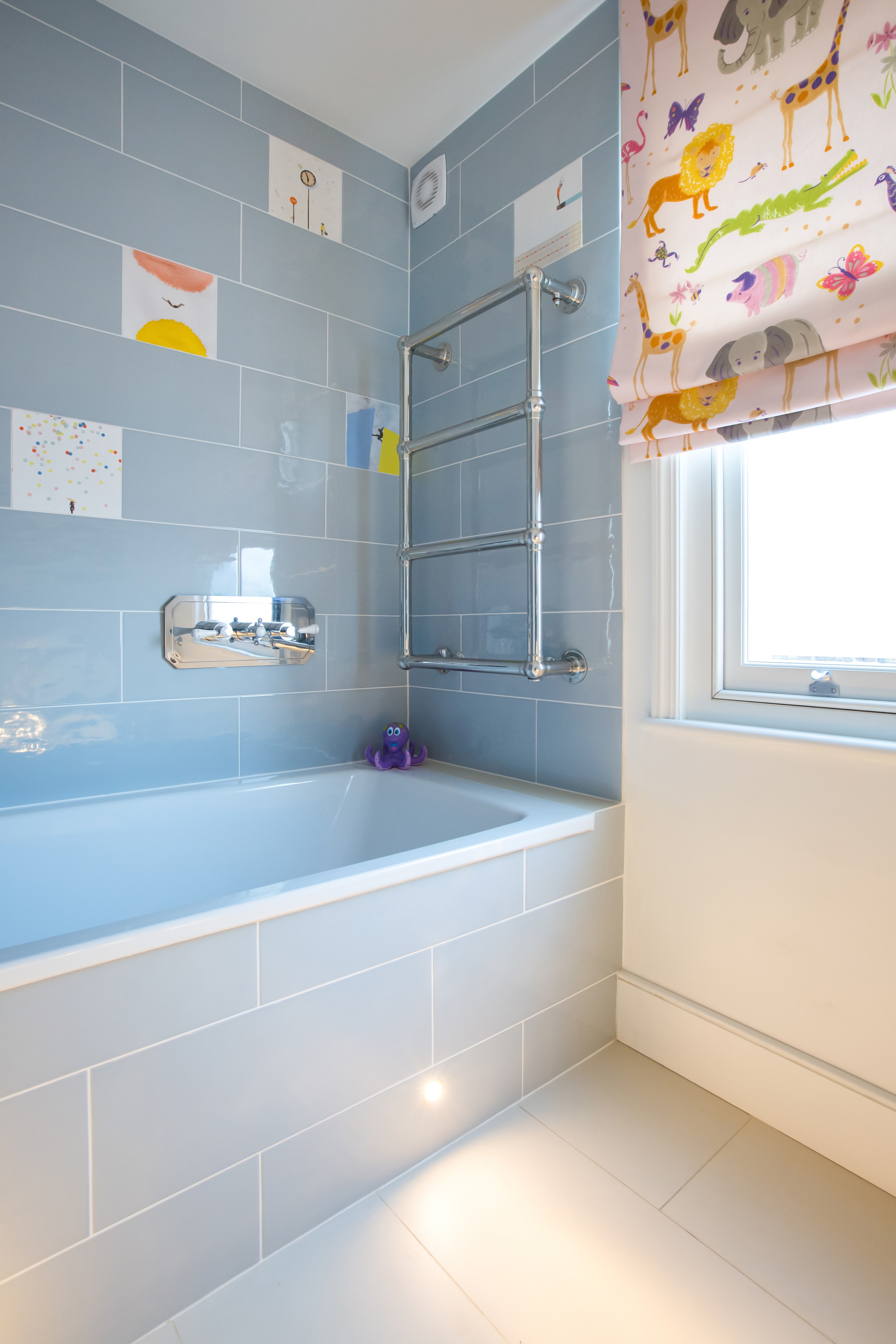 playful hand-made glazed tiles make this children's bathroom a joy. Sensor lights add practicality.