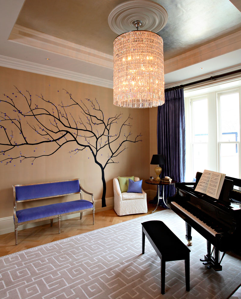 Music area seating with silk covered walls and crystal chandlier.