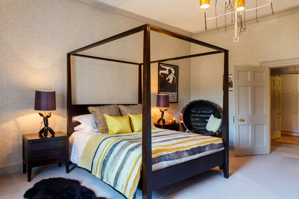 The boys’ guest suite continues the bespoke carpet but mixed with sharper charcoals, lemons, glass, and modern furniture