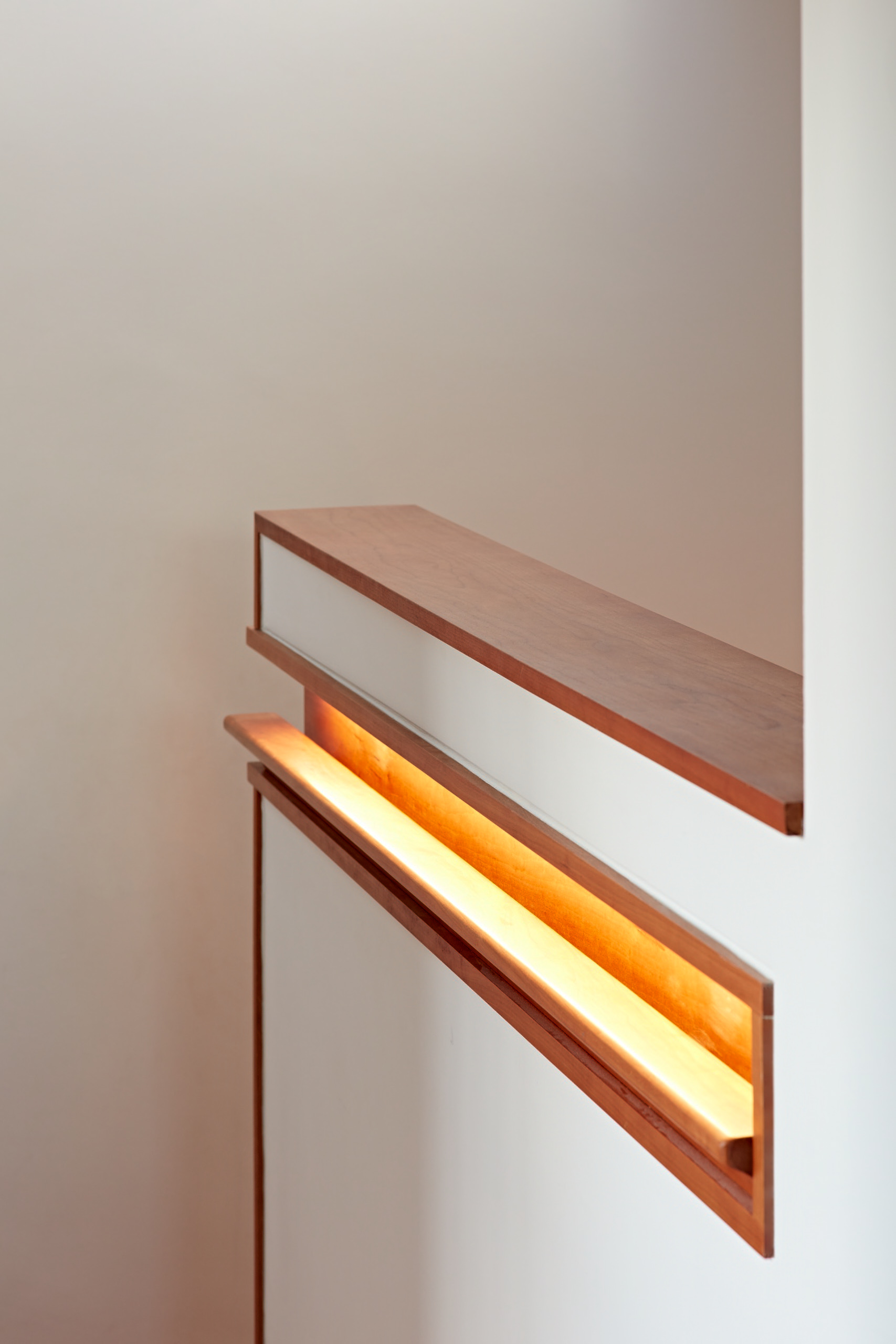 Staircase detail with inset handrail and concealed lighting leading up to the bedroom retreat.