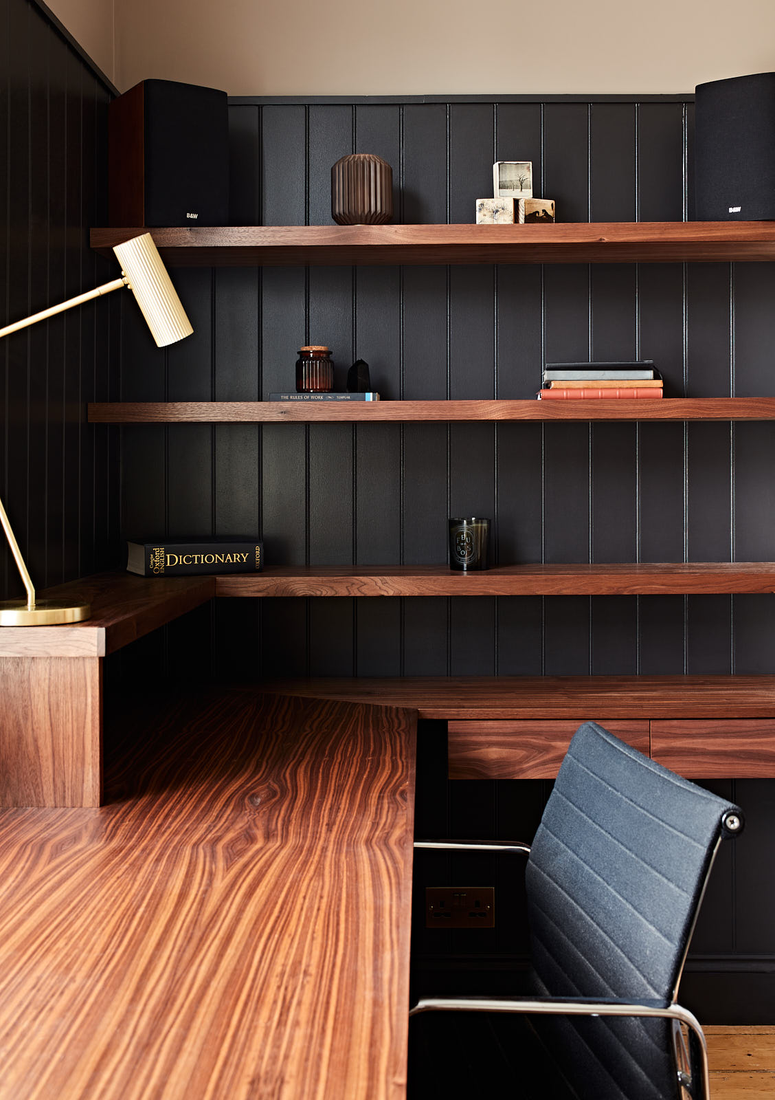 We designed a walnut desk with shelving to create a professional home office space in the spare bedroom.