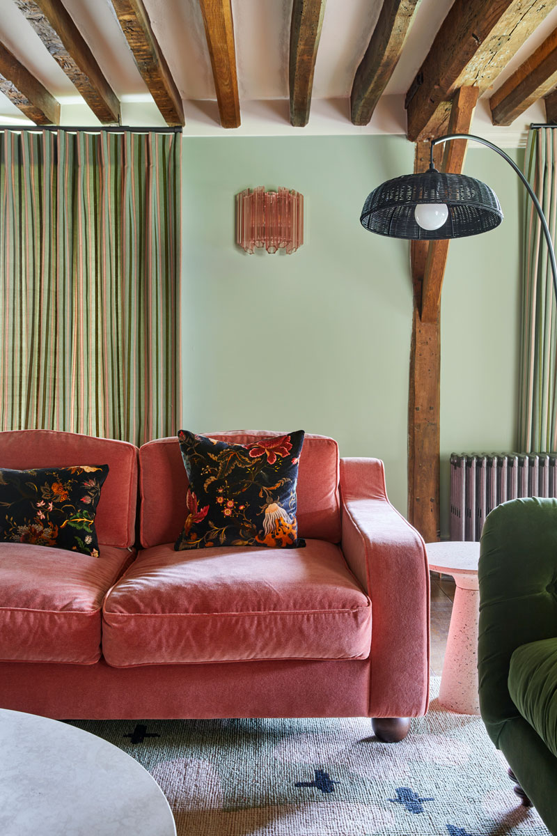 Living Room with pink sofa and curtains & murano wall light