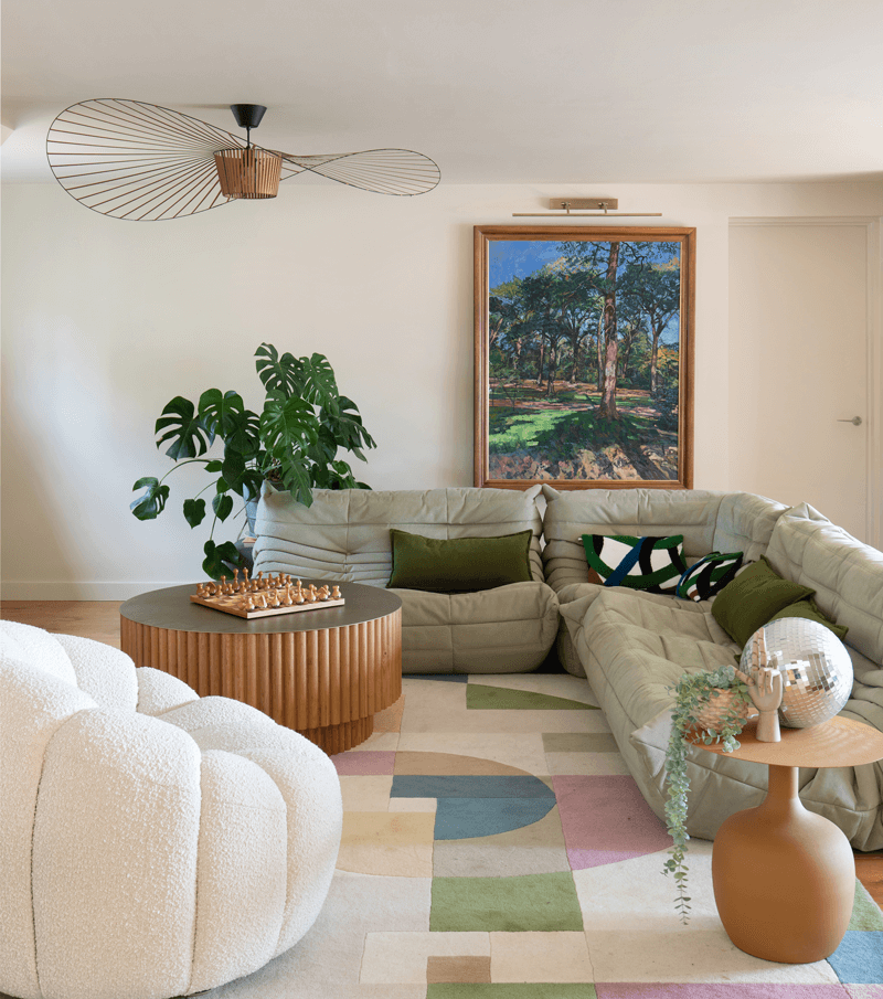 Living Room with Togo sofa bespoke rug and pendant and original artwork