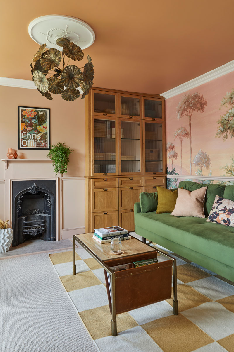 Home Office with bespoke bookcase, green sofa and mural