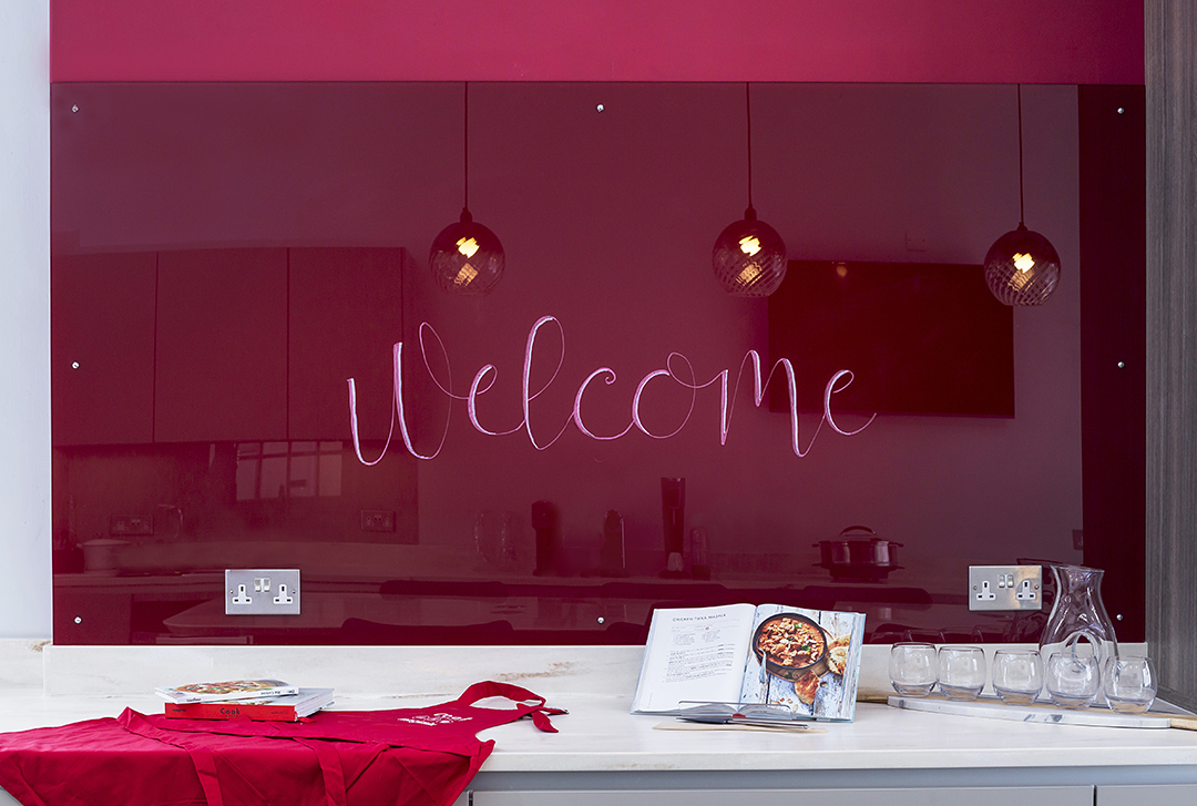 Welcome sign written on splashback