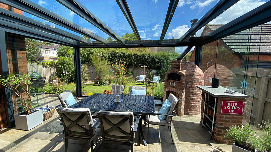 Grey framed glass room with integrated pizza oven