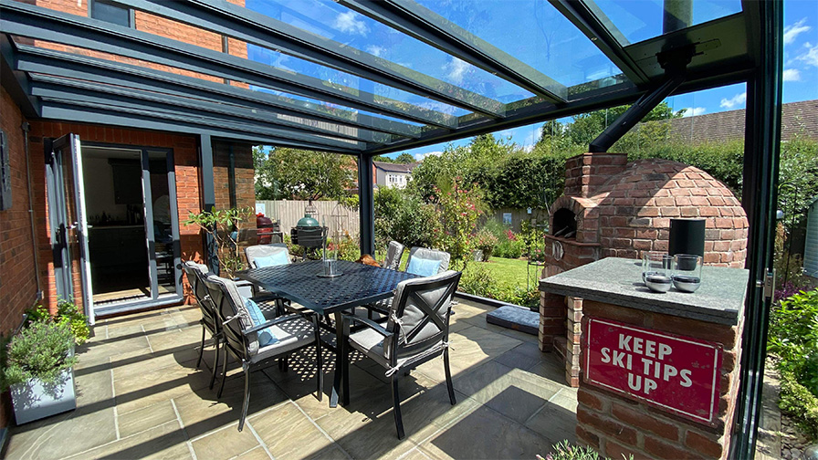 Grey framed glass room with integrated pizza oven