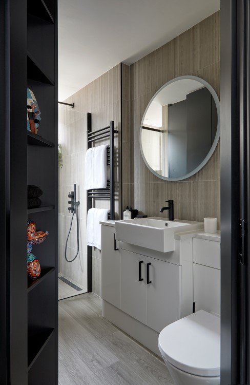 A surprisingly spacious shower room with utility cupboards