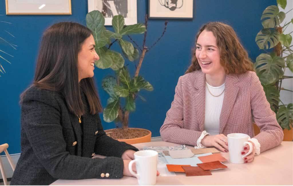 two smiling women at a table