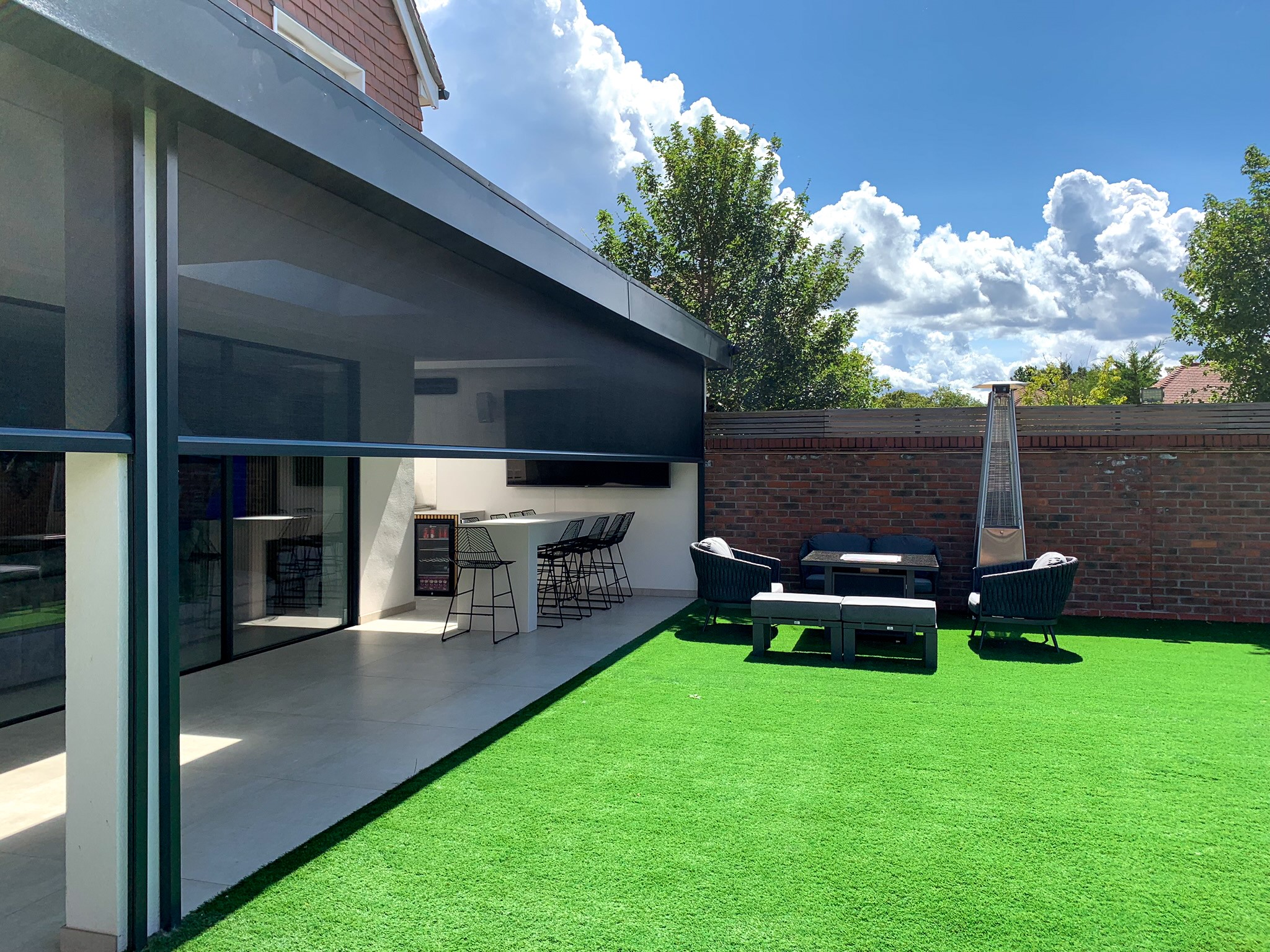 Phantom Screens’ automated solar screens seamlessly integrated into the architecture of a contemporary home