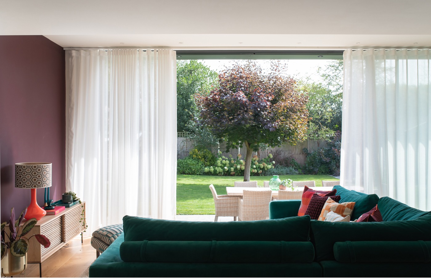 The bright garden contrasts beautifully against the autumnal tones of this room
