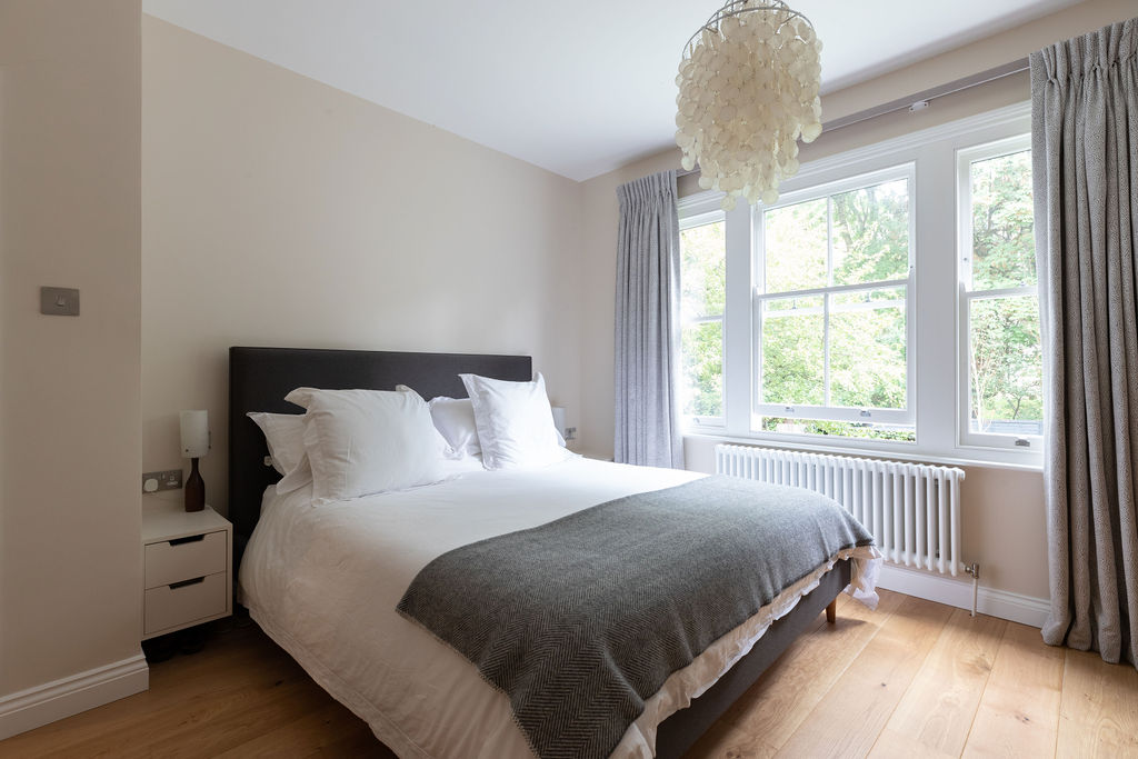 luxurious neutral and grey bedroomwith pearl chandelier