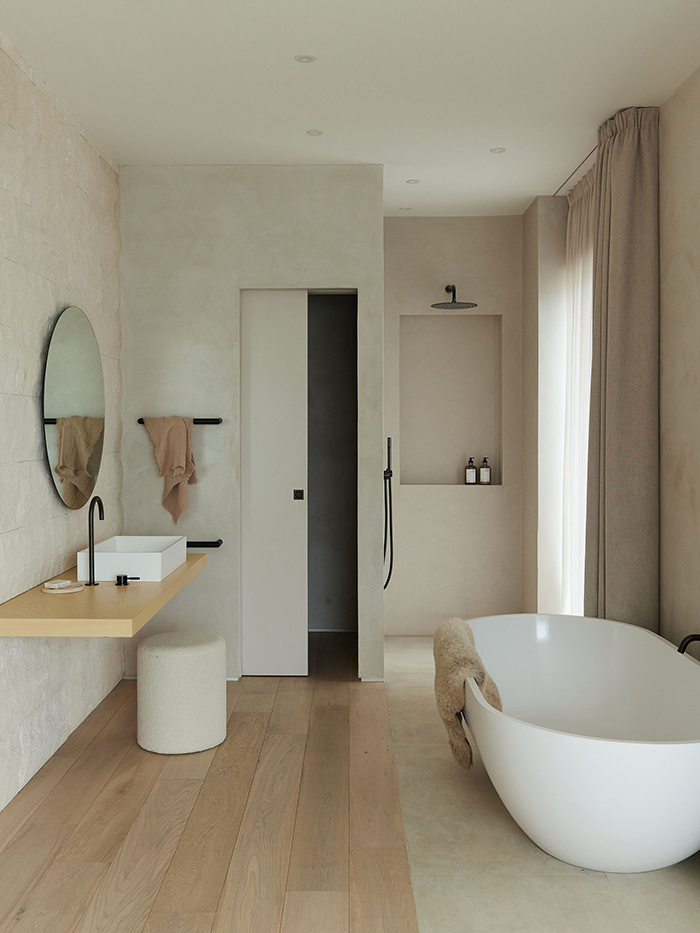 Guest wing open plan bathroom with walk in shower and bespoke vanity.