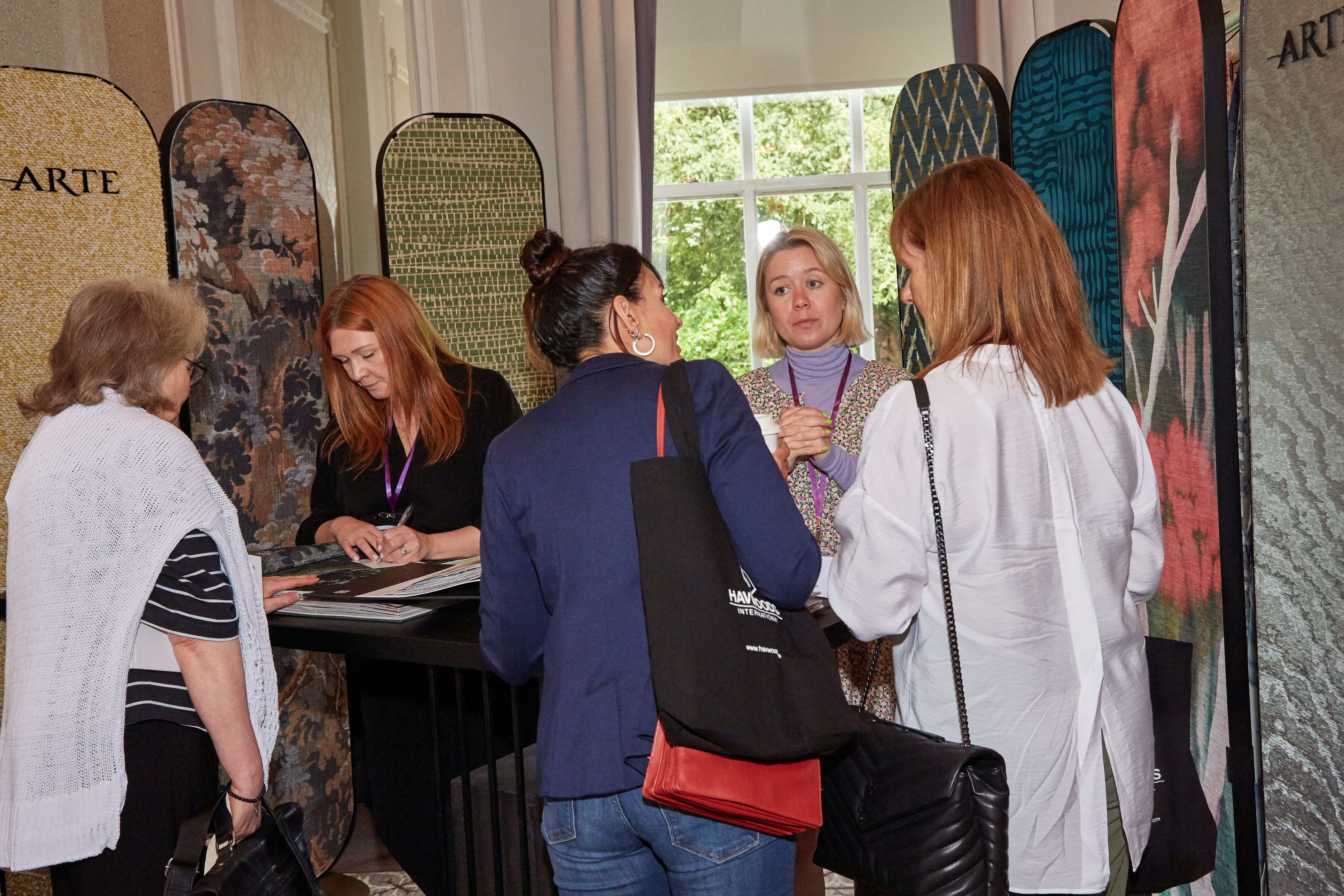 people looking at fabric samples.