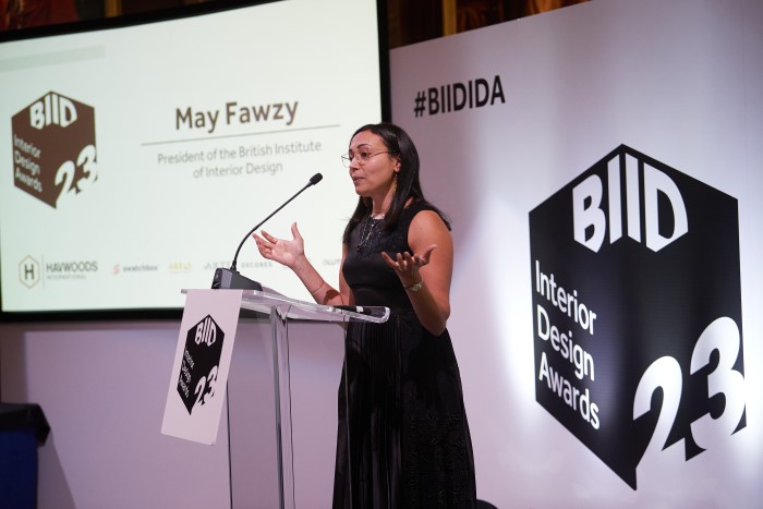 Dark haired woman talking from a podium