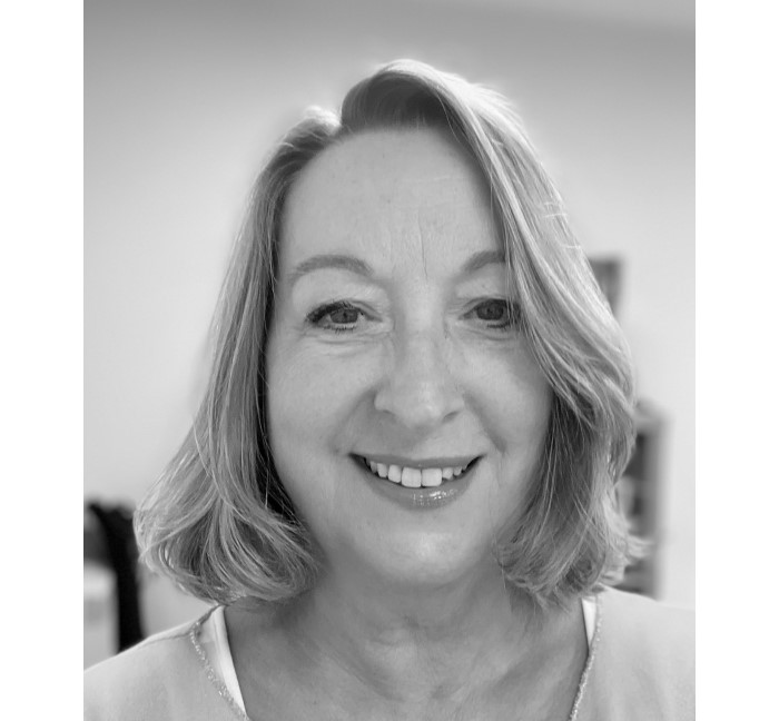 black and white image of a smiling woman.