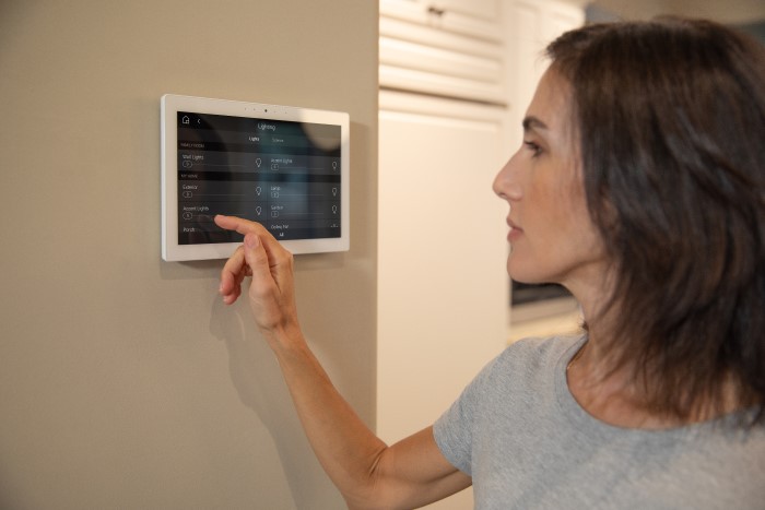 woman using home alarm