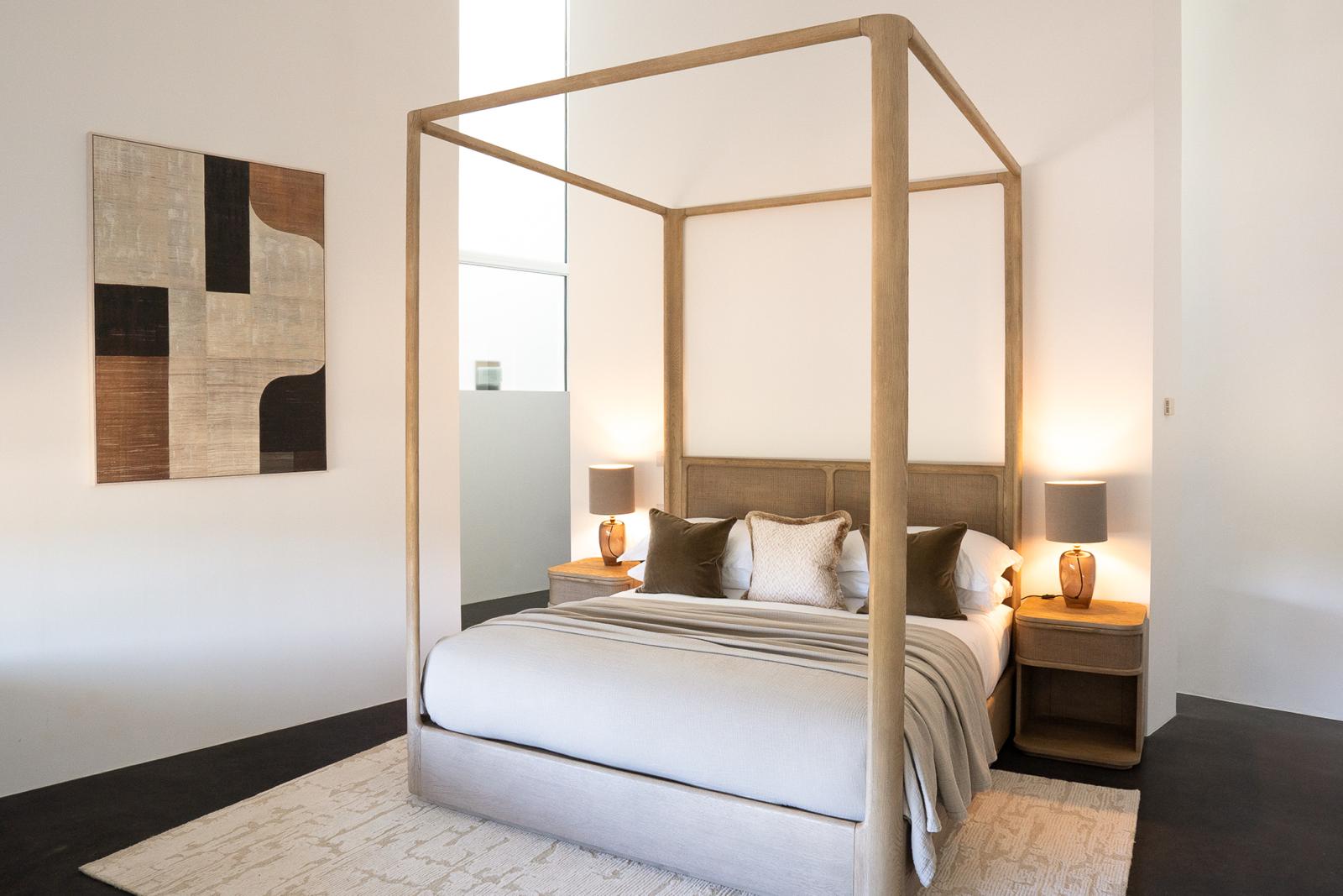 Contemporary bedroom with four-poster bed and layered neutrals – interior design by Kings Interiors Ltd, Berkshire.