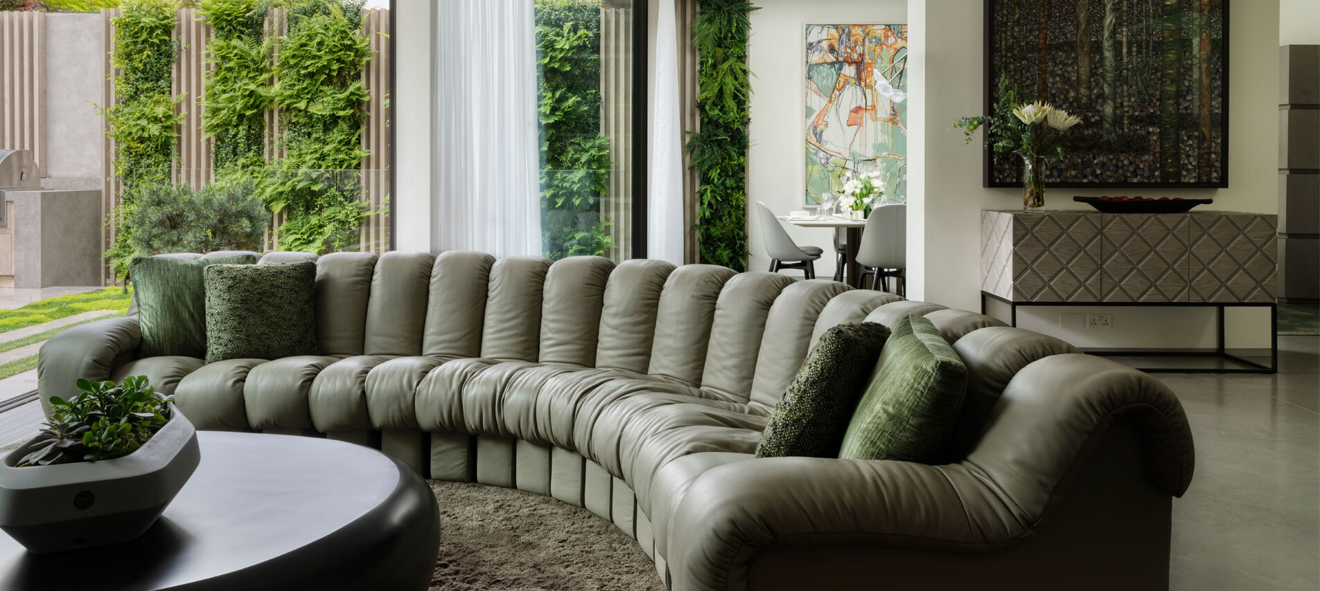 Living room with curved green sofa