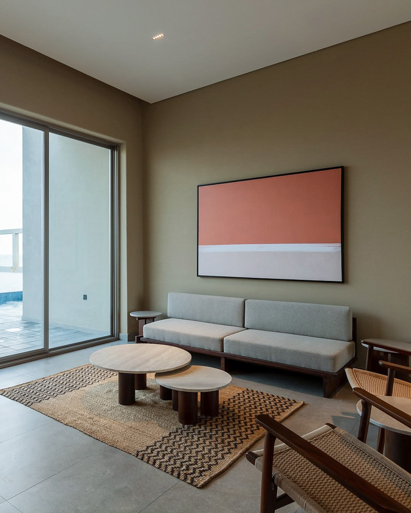 A patterned jute rug in a resort's indoor-outdoor space