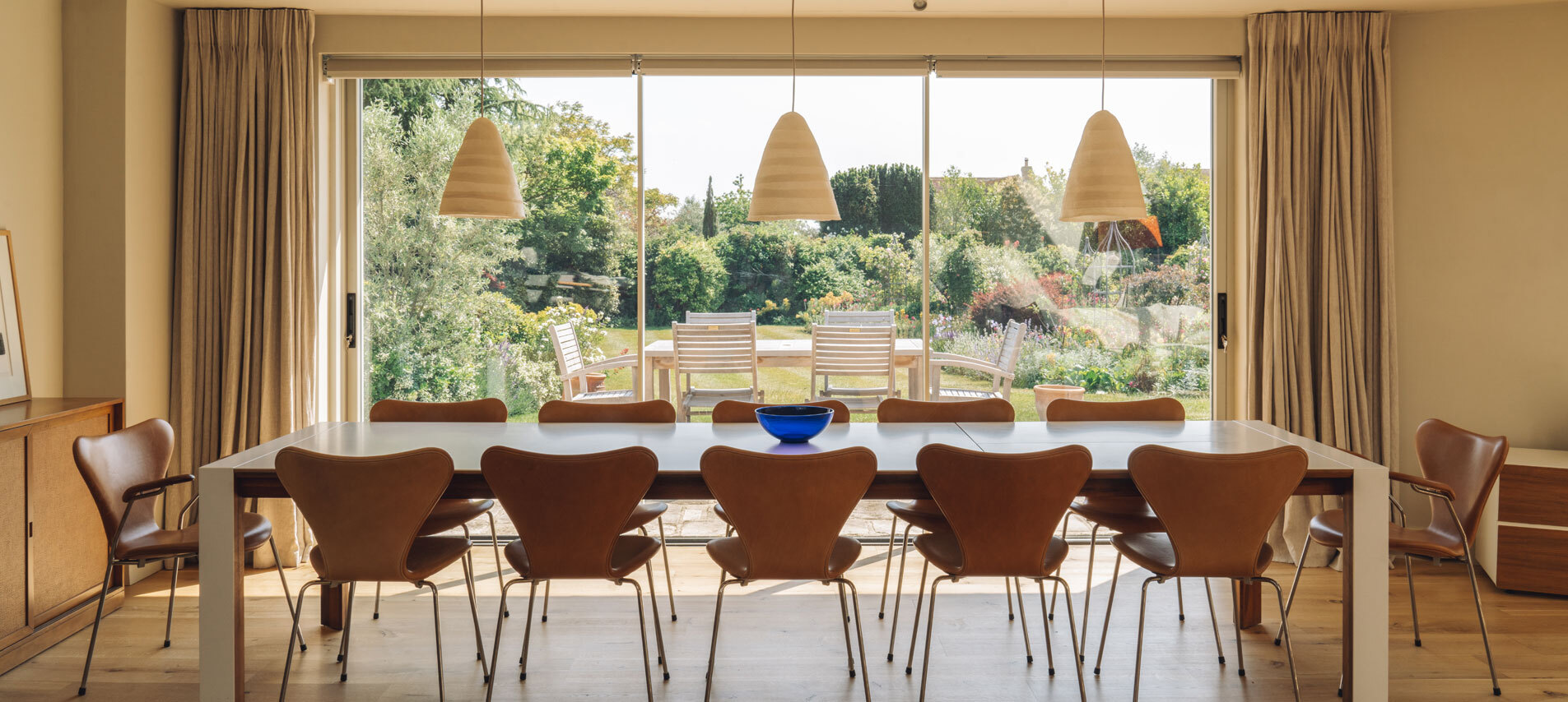 Dining table infront of large doors showing view