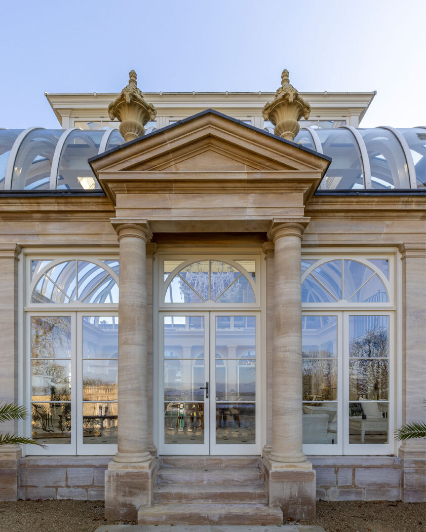Stone building with glass doors and roof