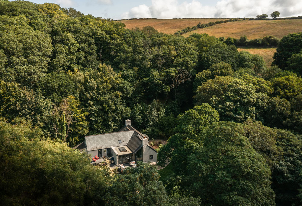 High up view of the house surround by woods