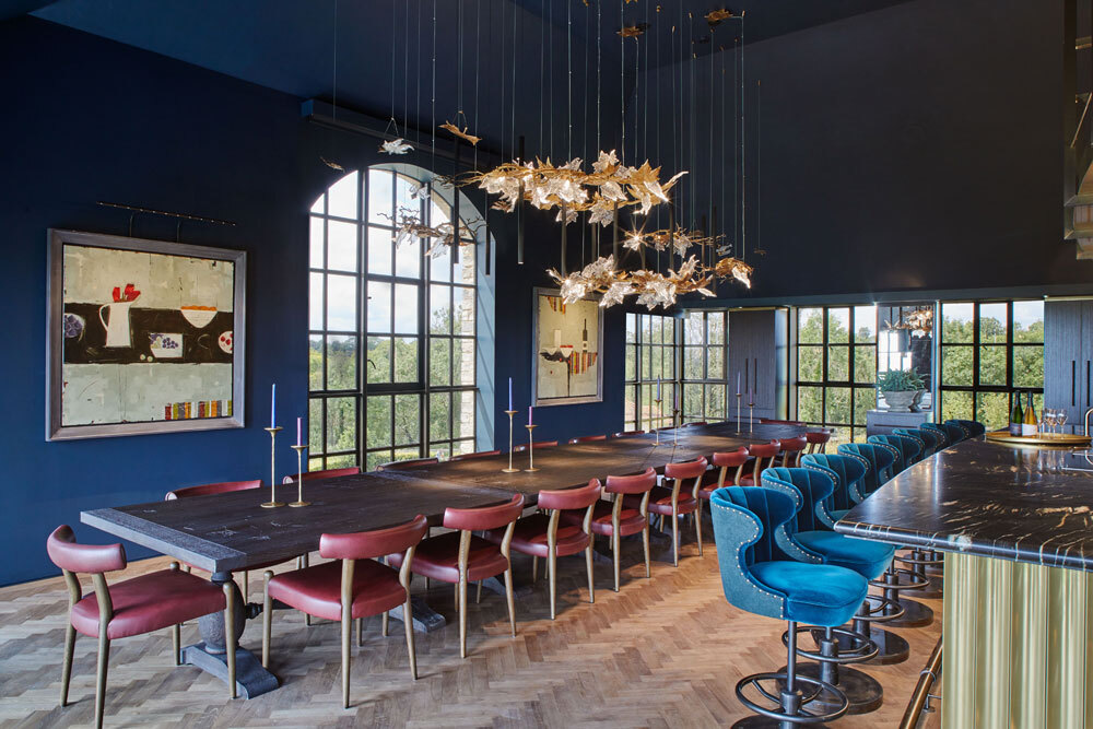 Large dining table with seats next to bar with seating