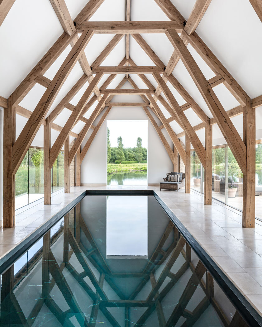 Swimming pool indoors with exposed wooden beams above