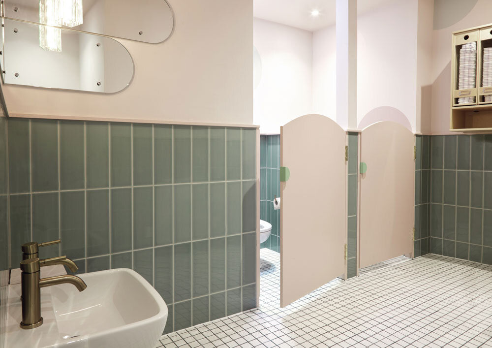 Childrens bathroom with green tiles