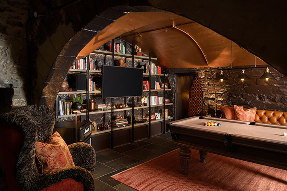 Pool table in room with bookshelf