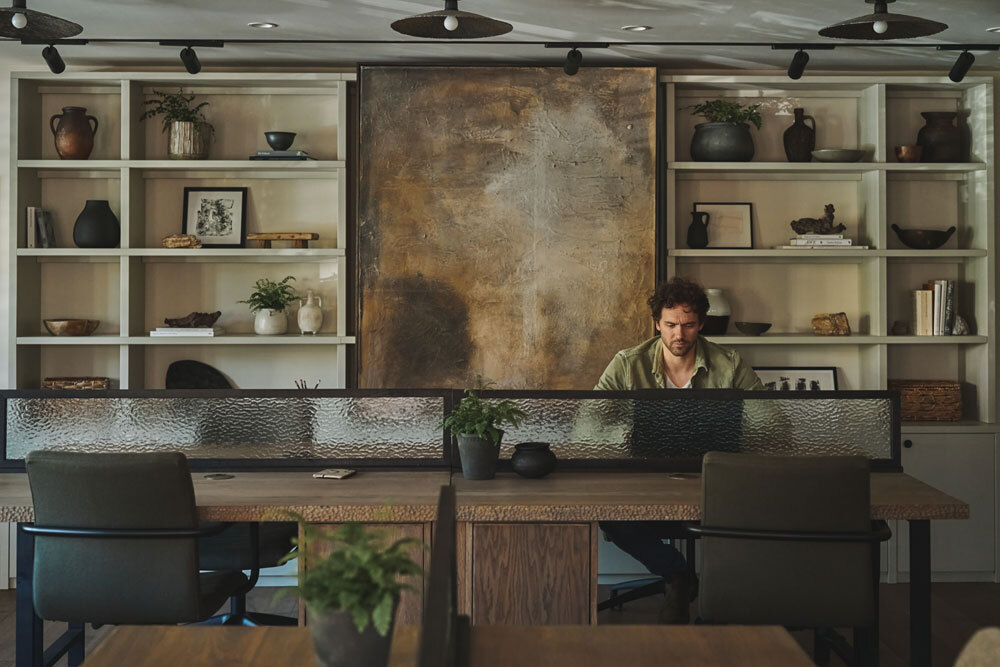 Seating area in cafe with person working on laptop