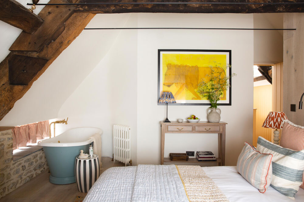 Bedroom with bed and freestanding bath