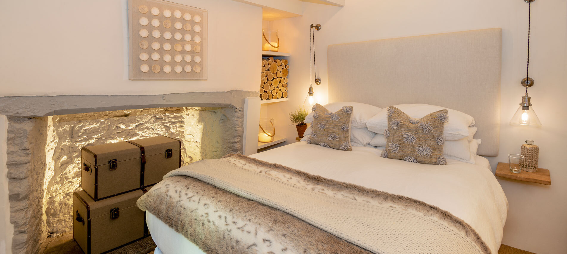 Bedroom with bed and fireplace holding baskets