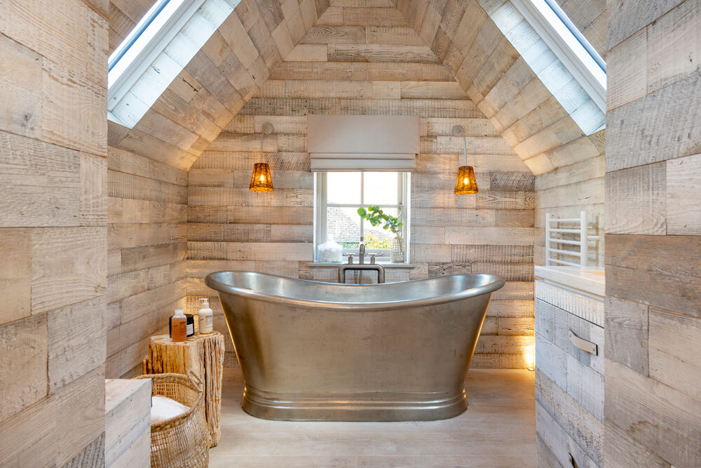 Silver bath in middle of bathroom