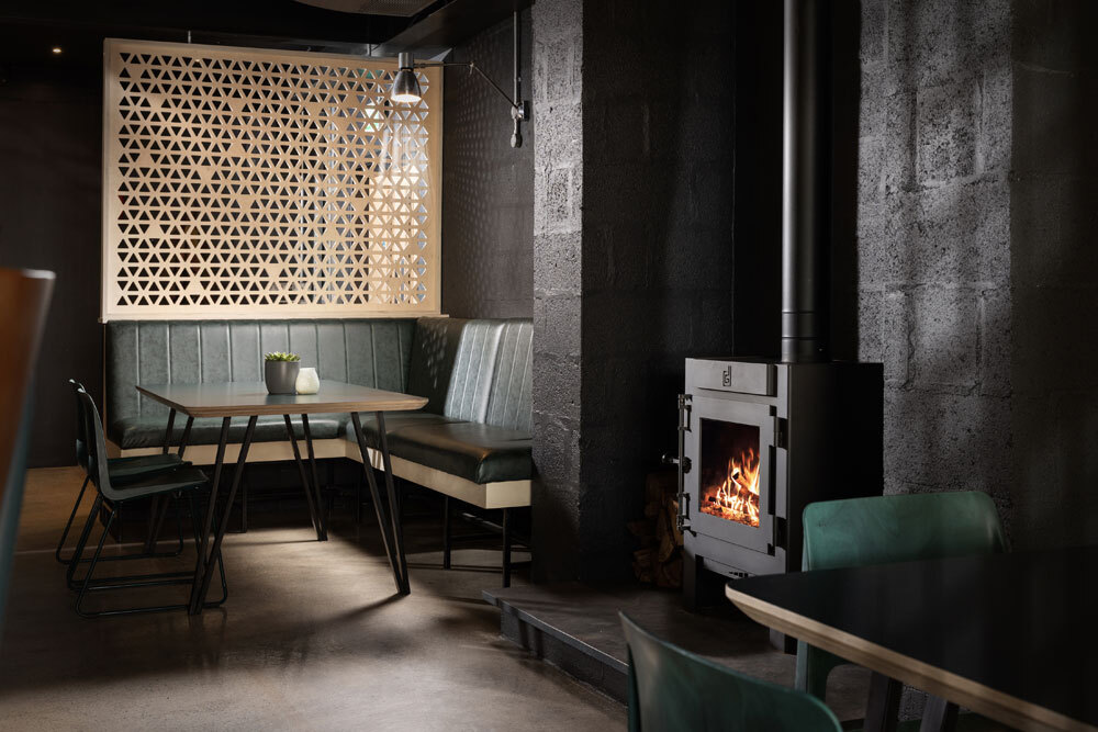 Dark room with log burner and seating