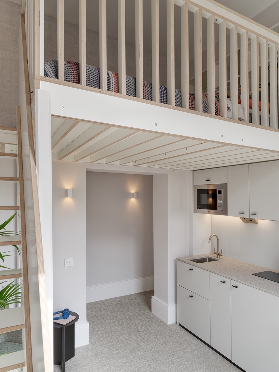 Room with upper level visable through wooden railings