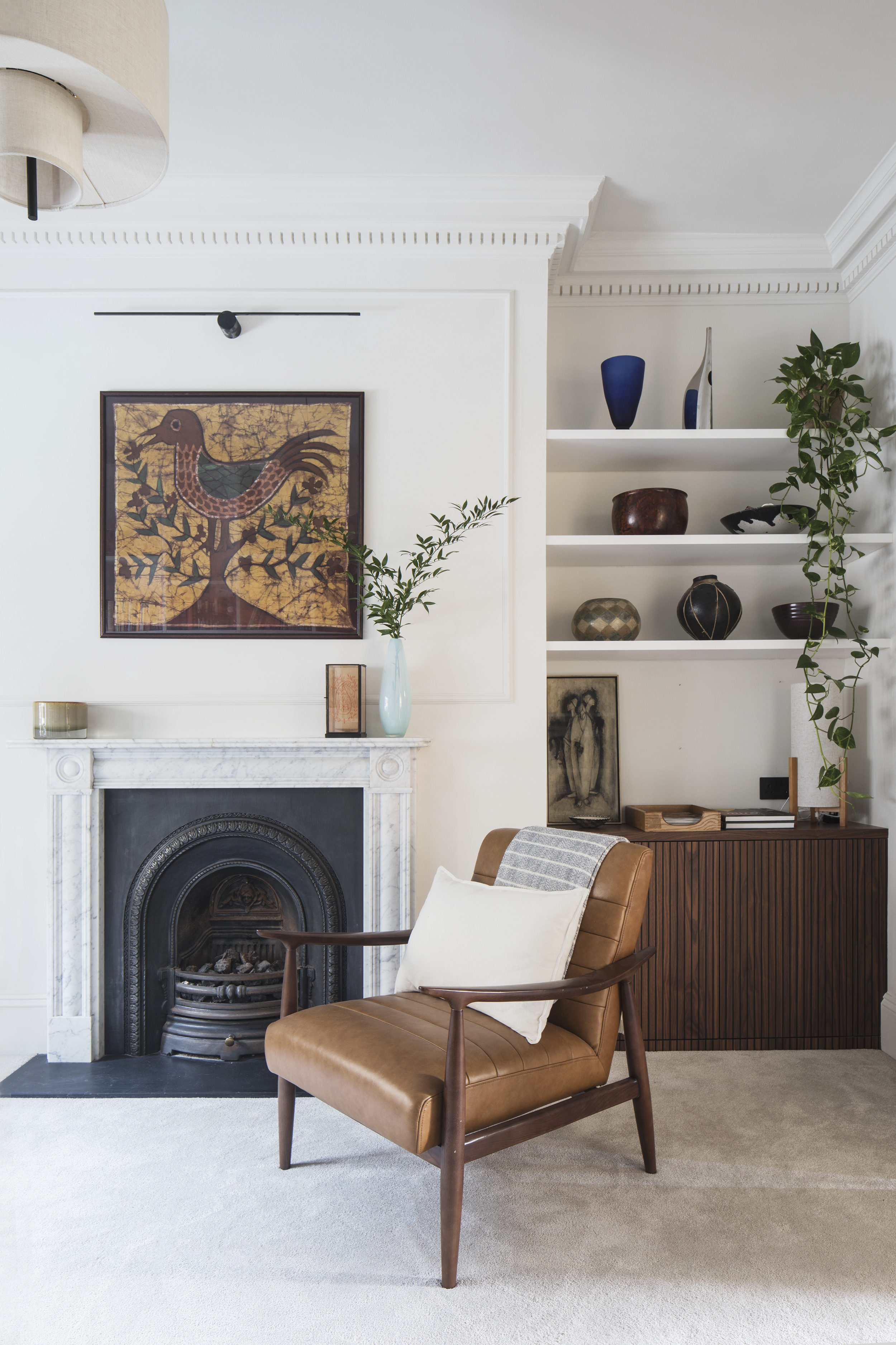 mid century lounge chair in Georgian study with bespoke storage in backgroundn 