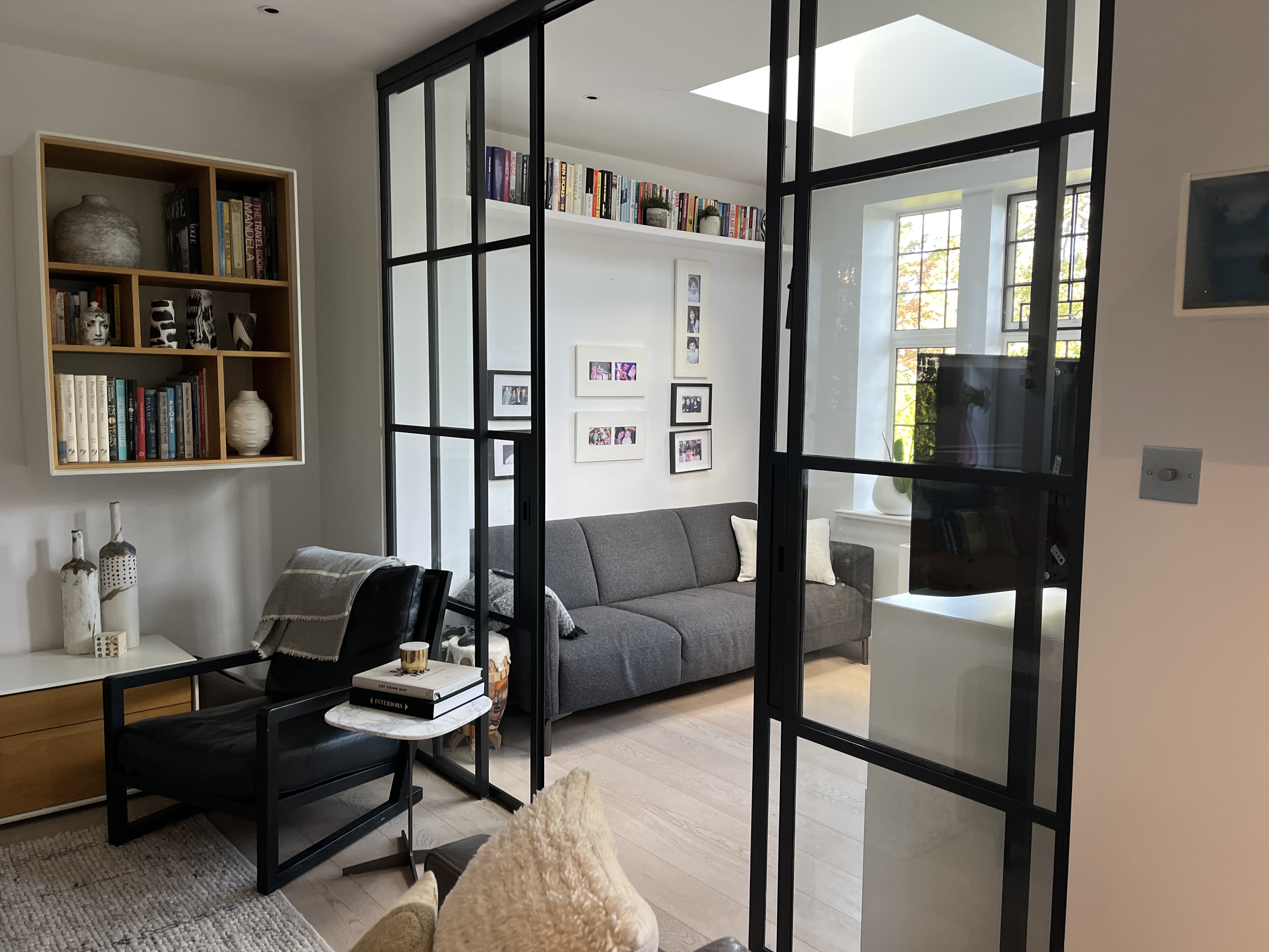 New room for work and gaming, with steel doors and new sofa and desk and storage joinery