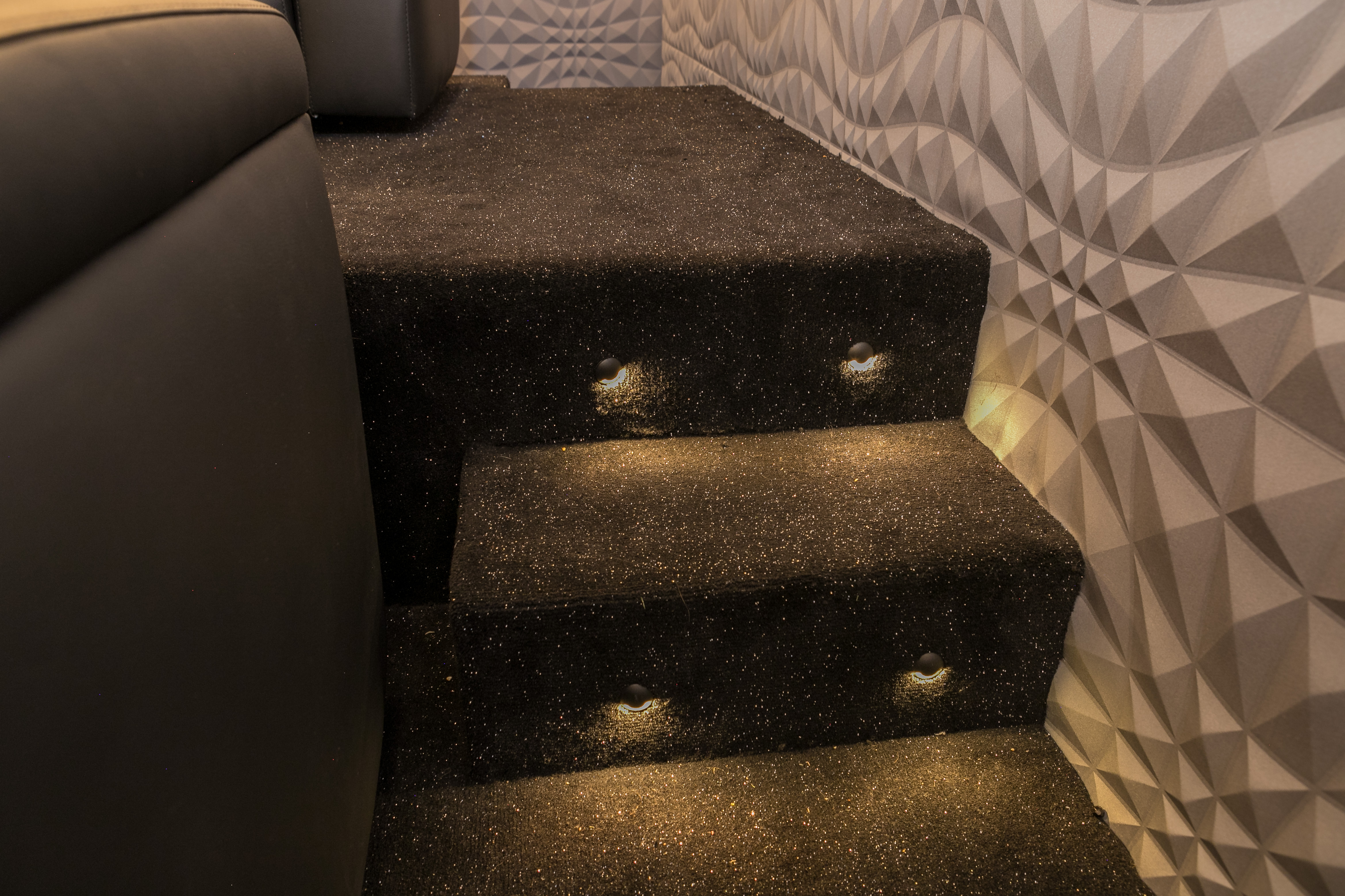 Sparkly carpet, step lights and textured, padded walls for the movie room