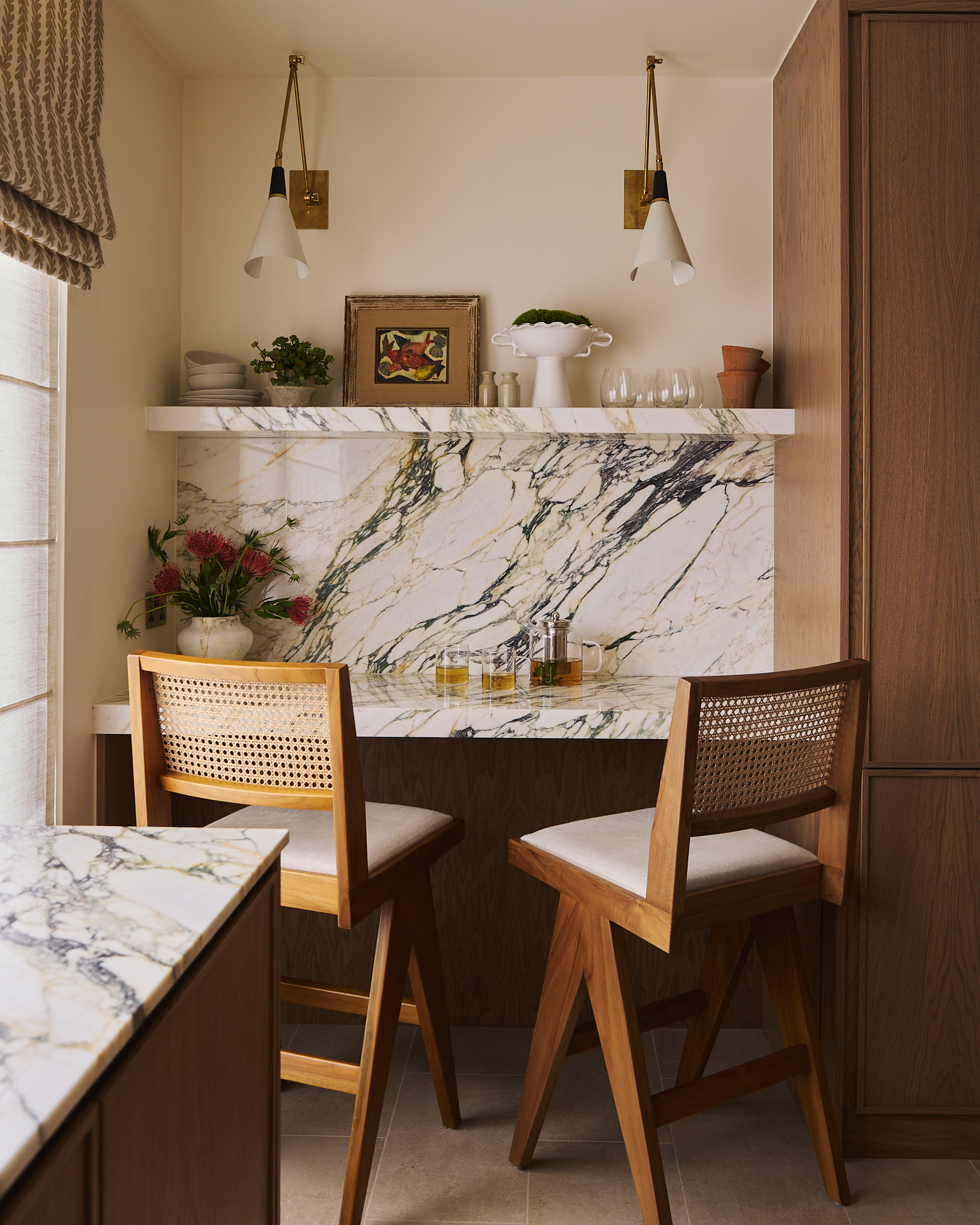 An intimate breakfast corner where warm timber, woven textures, and a marble backdrop come together to create a quiet, inviting space for everyday use.