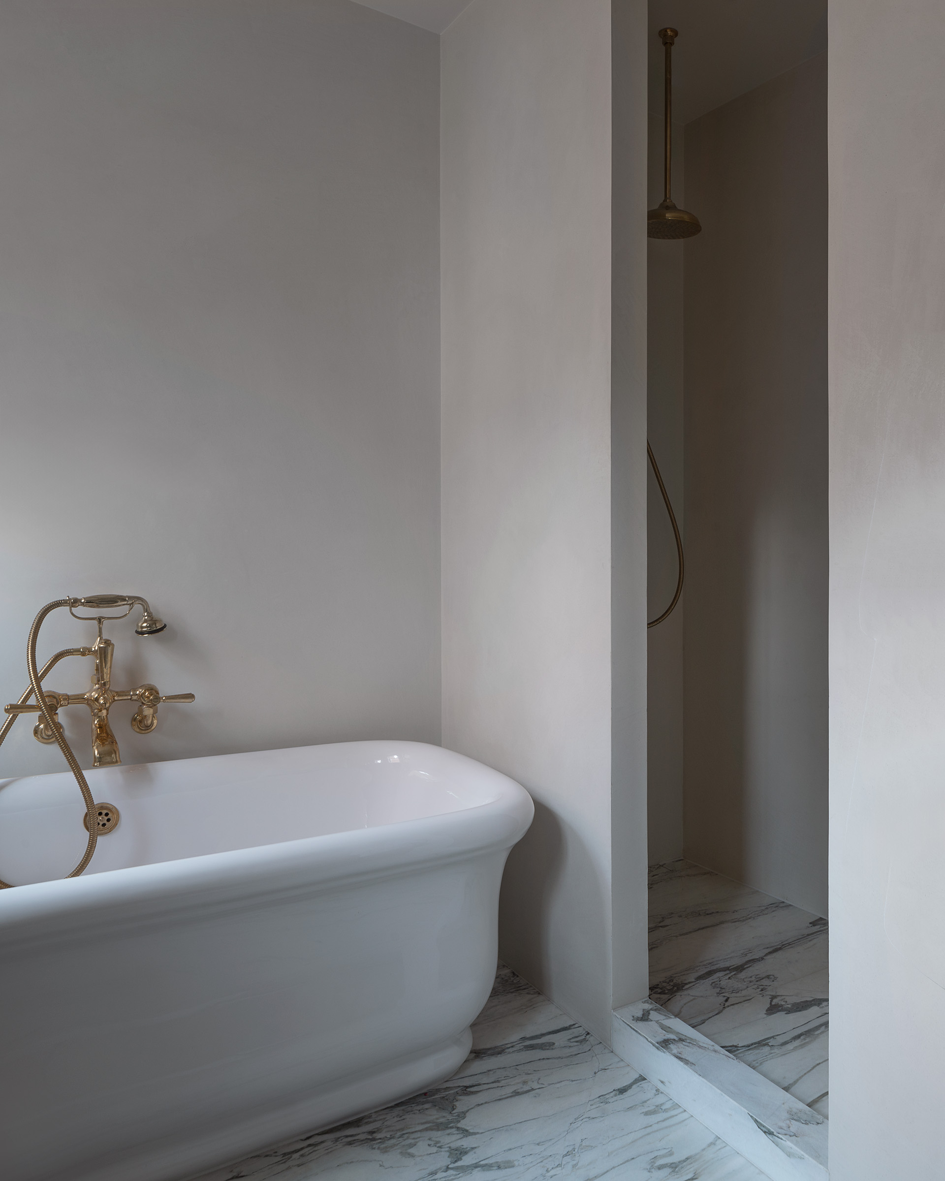 Architect designed bathroom interior in marble, brass and Tadelakt