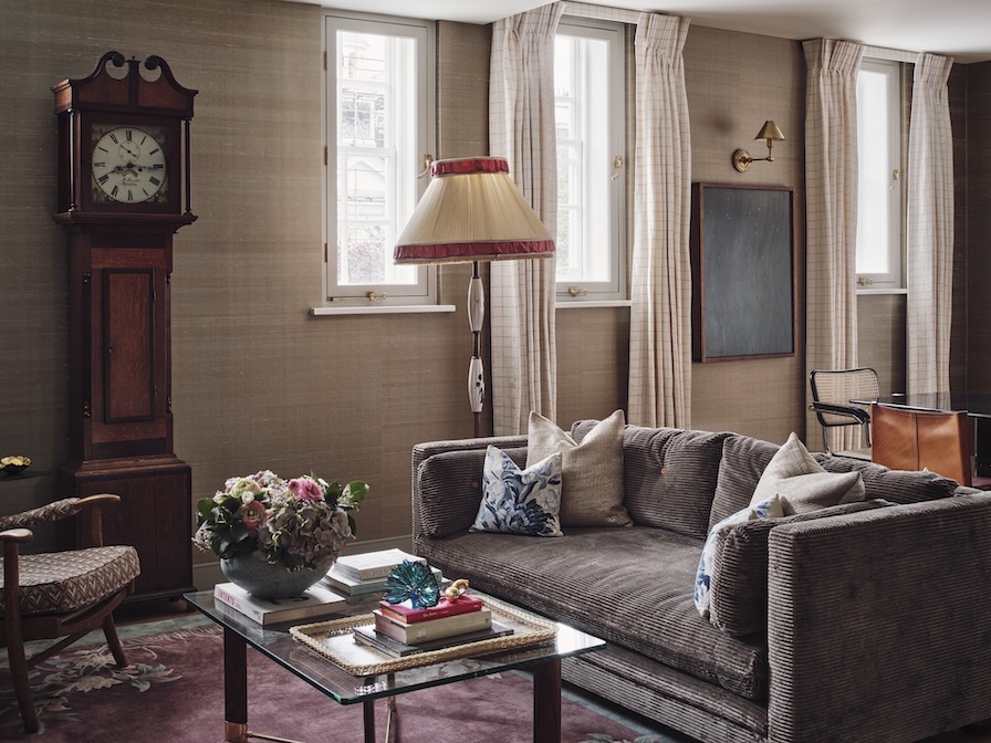 Sitting room with George Smith sofa, silk wallpaper, antique fireplace, and layered traditional furnishings