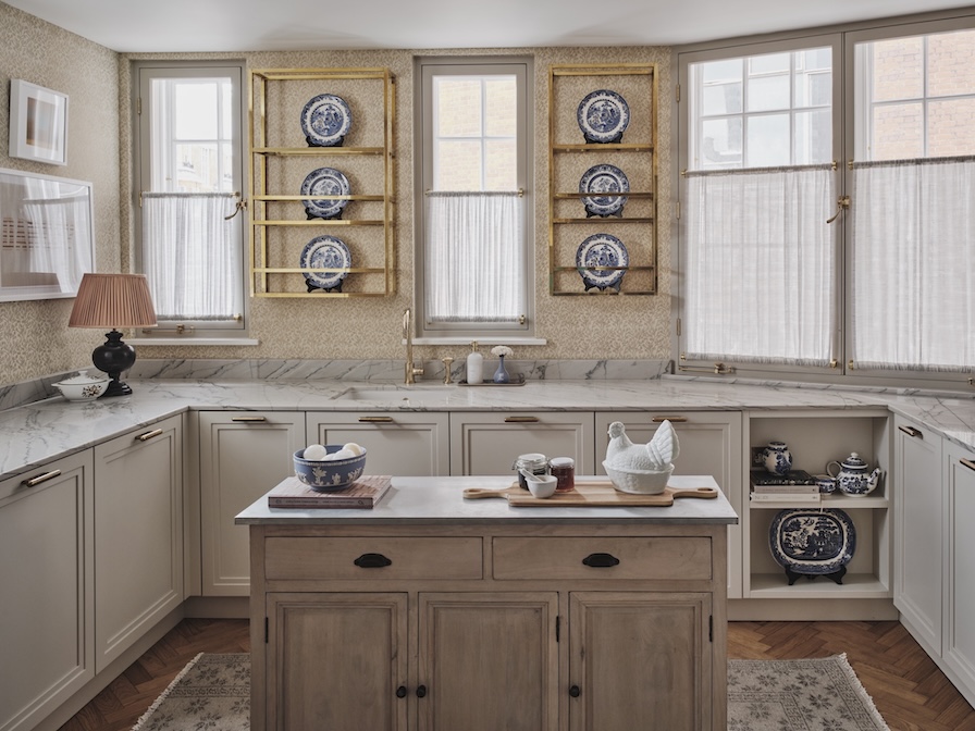 Bespoke kitchen with custom brass hardware, marble countertops, and, brass shelving in period property