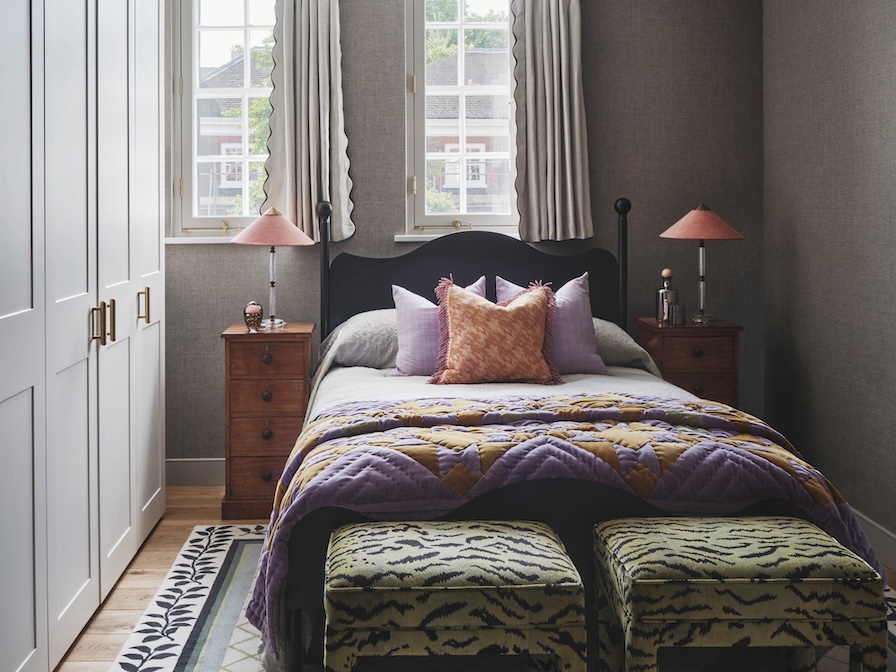 Guest bedroom with linen wallpaper, bespoke bed and Studio L designed rug, and eclectic styling