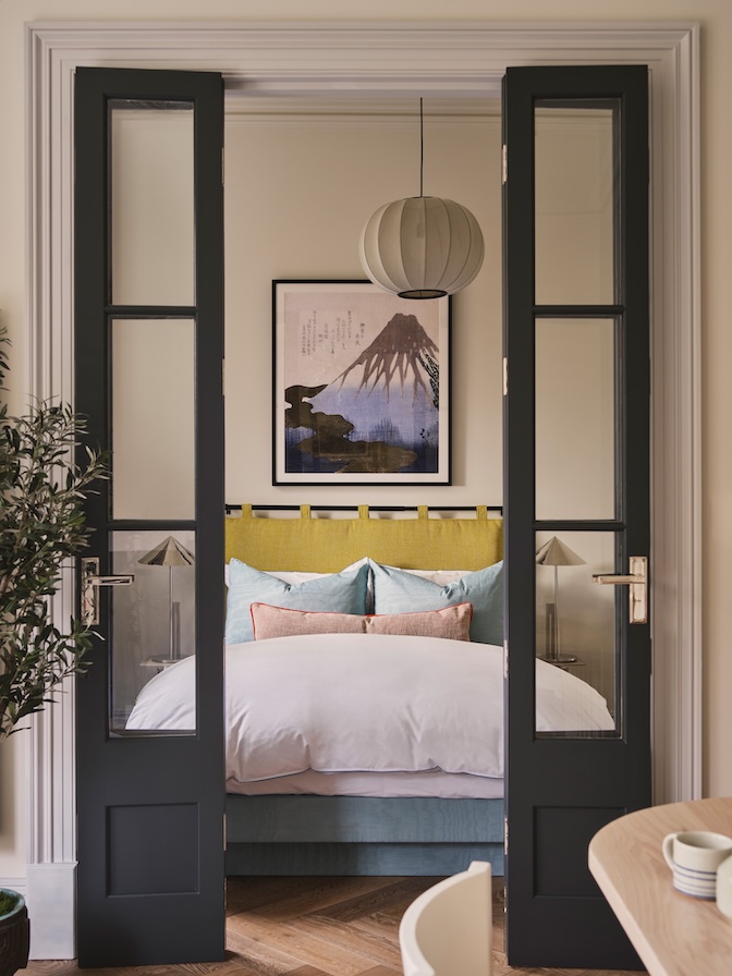 Bedroom with custom bi-fold French doors, custom Rubelli upholstery