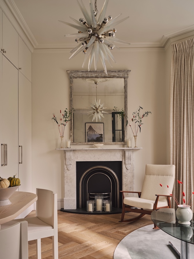Murano glass chandelier in neutral sitting room with custom wall paneling and upholstered furniture
