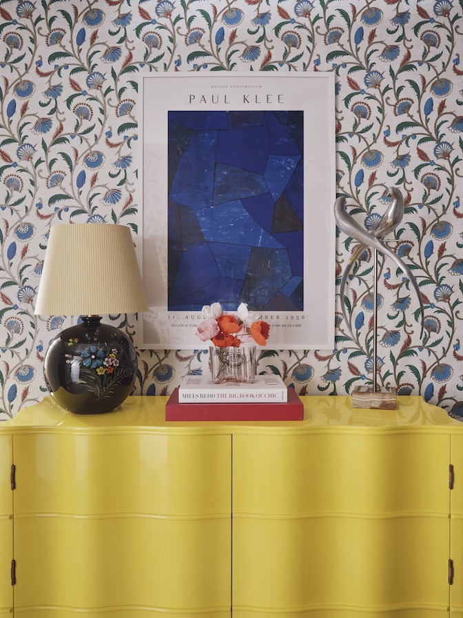 Hallway in a joyful Pierre Frey wallpaper, yellow lacquer cabinet  in Grade II listed apartment